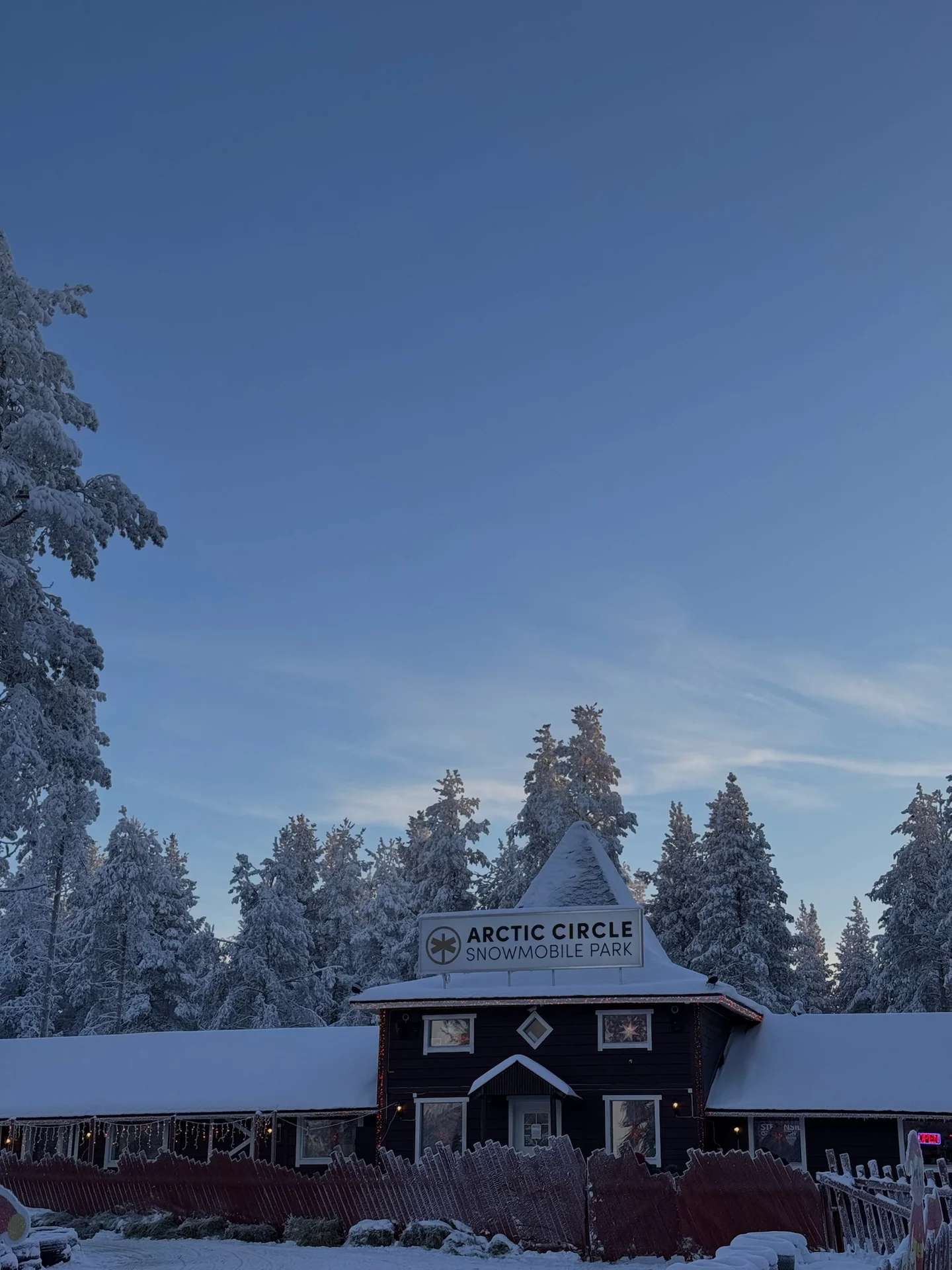Snow-covered Arctic Circle Snowmobile Park building at Santa Claus Village