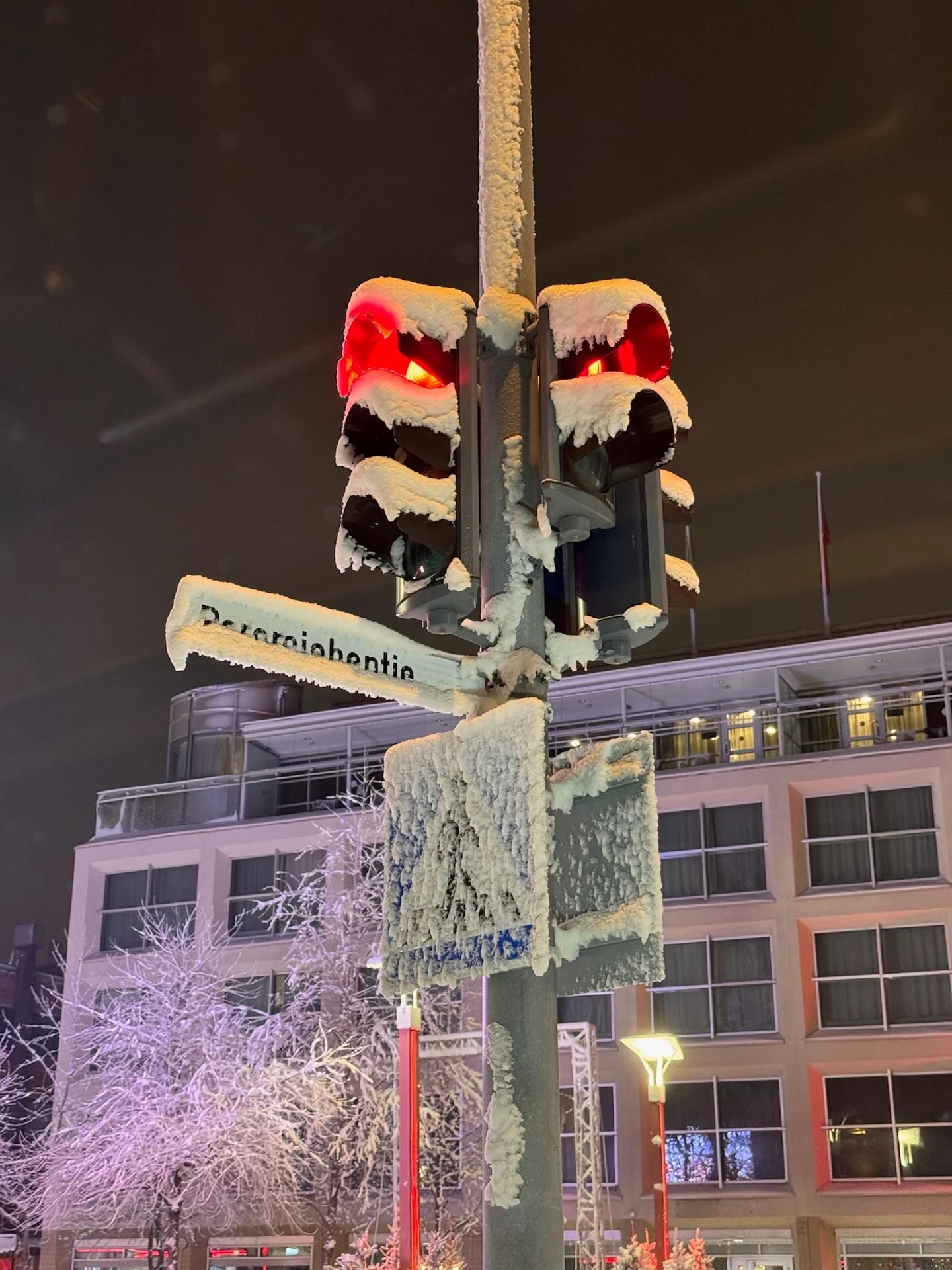 Traffic light rimmed with snow and frost on a winter night in Rovaniemi