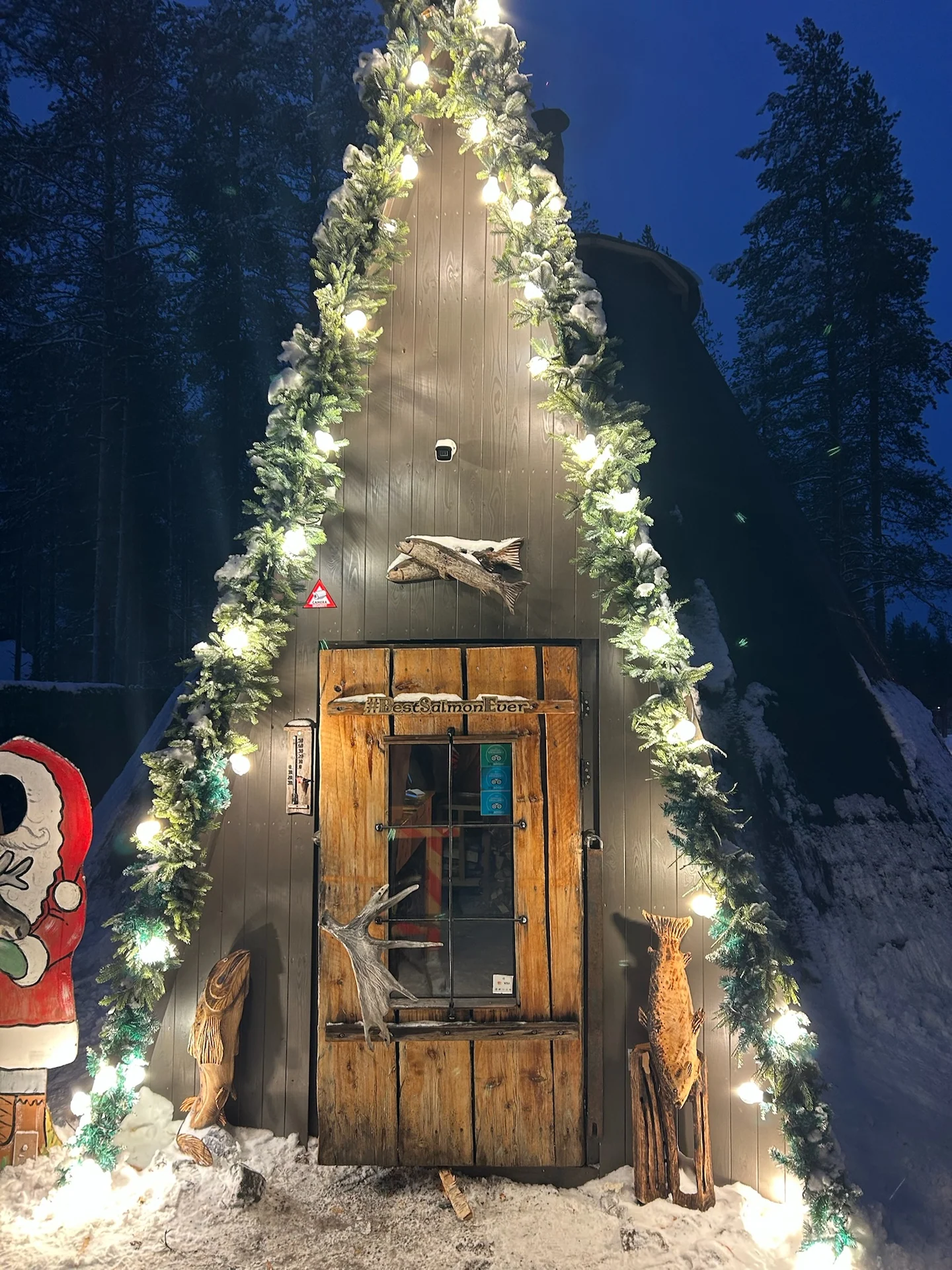 Snow-covered exterior of Santa's Salmon Place at Santa Claus Village